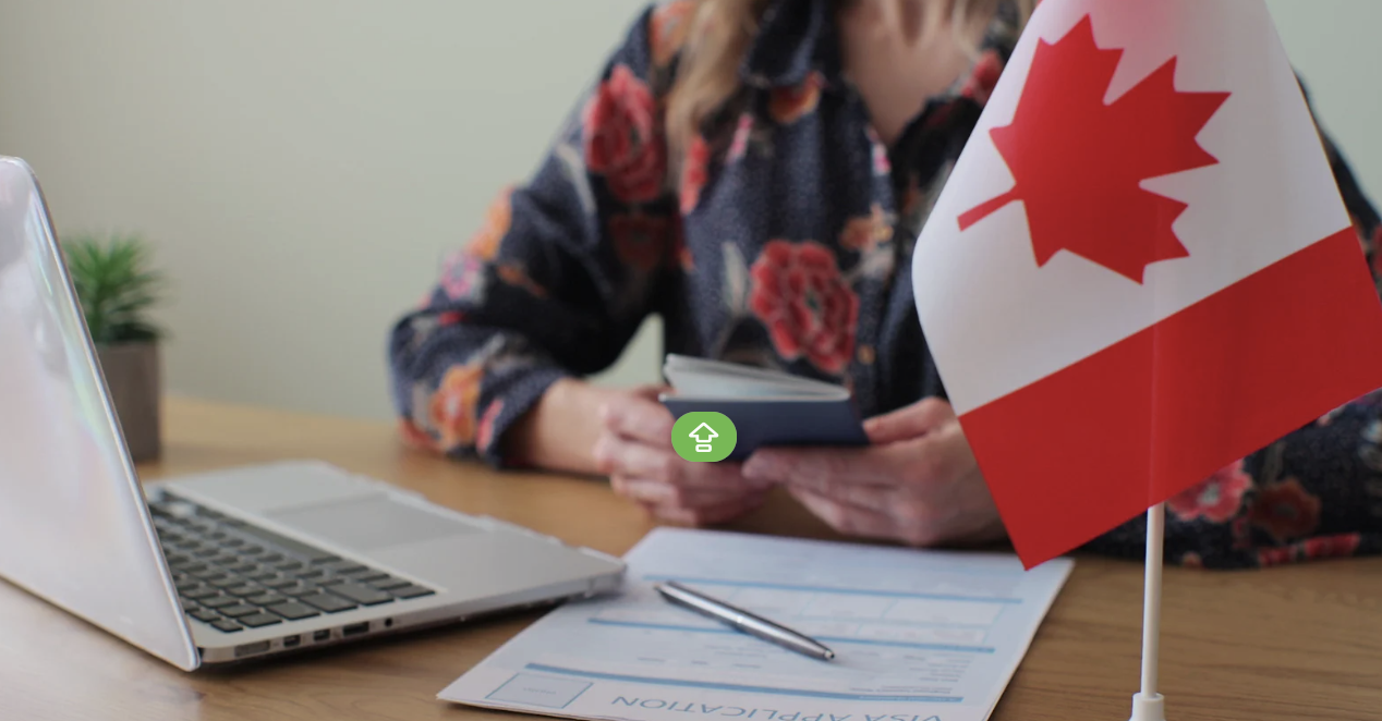Canadian flag on a desk with visa application materials